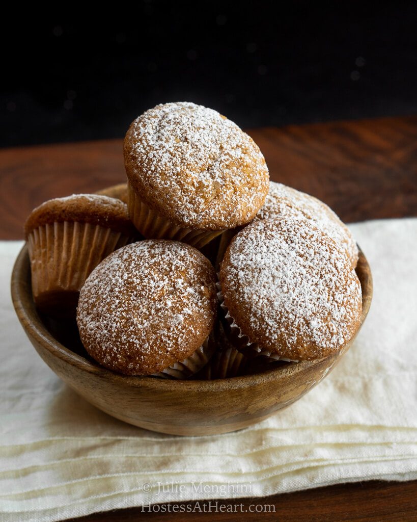 Crystallized Ginger Spice Mini Muffins are warm, tender and delicious with a nice amount of sweetness and spice. They're the perfect size for sharing! Wooden bowl filled with muffins