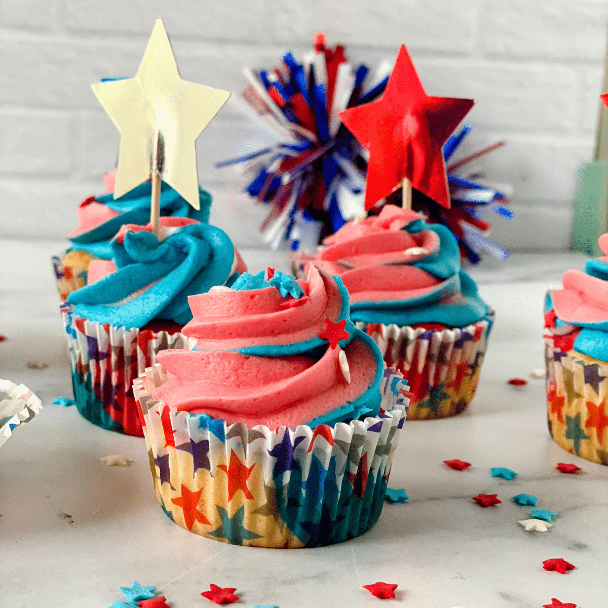 Red, White, and Blue cupcakes with swirled frosting in star cupcake liners
