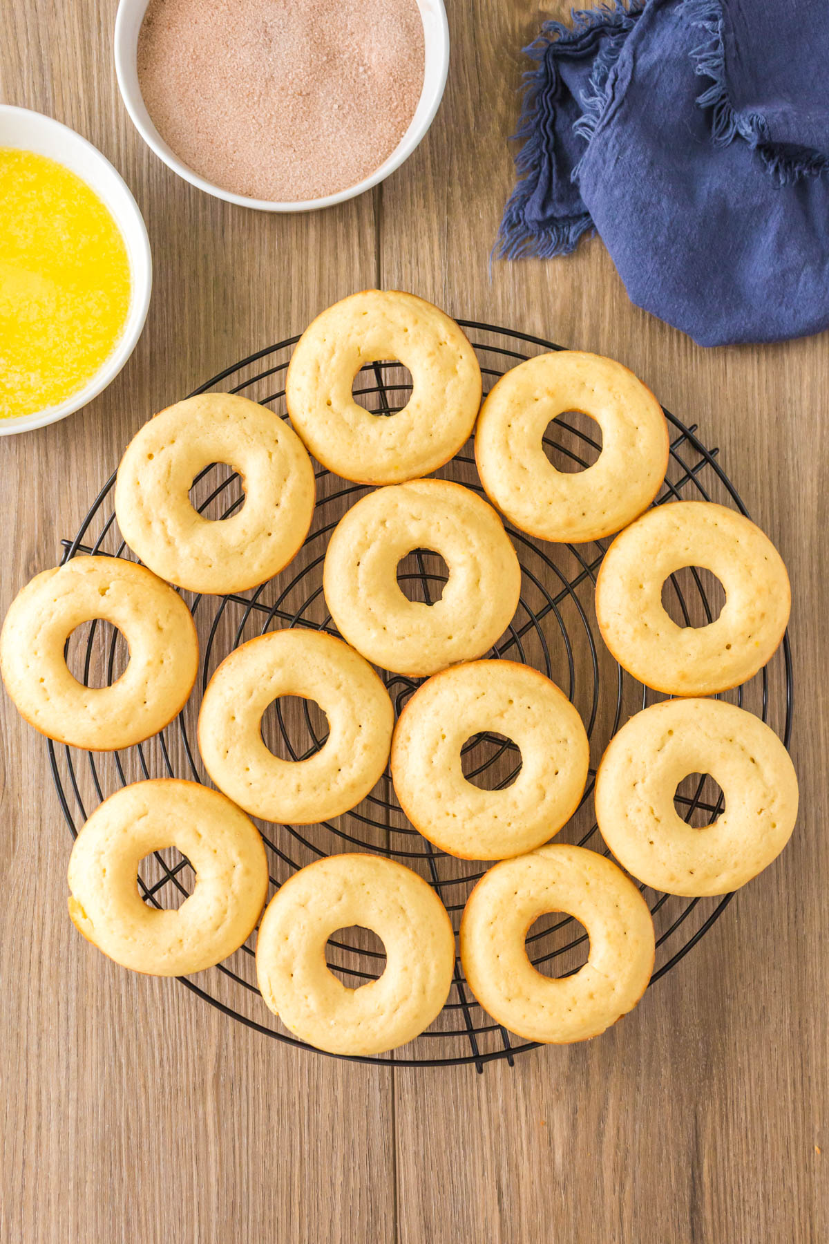 Baked donuts cooling on a cooling rack.